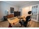 Bright home office space with wood floors, natural light, and a modern desk and chair at 9741 Haughton Ln, McCordsville, IN 46055