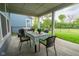 Covered patio with outdoor dining table and chairs, BBQ, overlooking the fenced backyard at 9741 Haughton Ln, McCordsville, IN 46055
