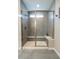Modern shower featuring grey tiled walls, a glass enclosure, and a built-in bench at 9741 Haughton Ln, McCordsville, IN 46055