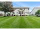 Spacious backyard with a well-kept lawn, patio areas, and mature trees, perfect for outdoor entertaining at 9756 Brook Meadow Dr, McCordsville, IN 46055