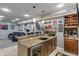 Entertainers bar area with granite counters, bar refrigerator, and convenient access to seating at 9756 Brook Meadow Dr, McCordsville, IN 46055