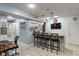 Stylish bar area with seating, granite countertops, brick accents, and a mounted television at 9756 Brook Meadow Dr, McCordsville, IN 46055