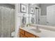 Bathroom featuring a wood vanity, shower, and large mirror at 9756 Brook Meadow Dr, McCordsville, IN 46055