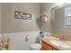 Charming half bathroom featuring wainscoting and a decorative vanity at 9756 Brook Meadow Dr, McCordsville, IN 46055