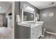 Bathroom vanity with marble countertops, gray walls, and luxury lighting at 9756 Brook Meadow Dr, McCordsville, IN 46055