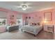 Bright bedroom with two large windows, pink walls, and ceiling fan at 9756 Brook Meadow Dr, McCordsville, IN 46055