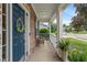 Charming front porch featuring classic columns, brick accents, and a cozy seating area at 9756 Brook Meadow Dr, McCordsville, IN 46055