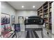 Home gym featuring a treadmill, sports memorabilia, and built-in bookshelves at 9756 Brook Meadow Dr, McCordsville, IN 46055