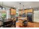 Well-lit kitchen featuring stainless steel appliances, an island with bar seating, and hardwood floors at 9756 Brook Meadow Dr, McCordsville, IN 46055