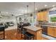 Open kitchen and living area featuring hardwood floors, an island with bar seating, and stainless appliances at 9756 Brook Meadow Dr, McCordsville, IN 46055