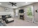Inviting living room with a cozy fireplace, a comfortable sofa, and plenty of natural light at 9756 Brook Meadow Dr, McCordsville, IN 46055