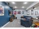 Comfortable living room featuring a large blue sofa, entertainment center, and ample space for activities at 9756 Brook Meadow Dr, McCordsville, IN 46055