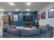Inviting living room with a large blue sofa, a fireplace, and a mounted television at 9756 Brook Meadow Dr, McCordsville, IN 46055