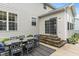 Outdoor patio area with a dining set, sliding glass doors, and a well-maintained exterior at 9756 Brook Meadow Dr, McCordsville, IN 46055