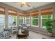 Cozy sunroom filled with natural light from numerous windows and featuring comfortable seating at 9756 Brook Meadow Dr, McCordsville, IN 46055