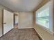 Bedroom featuring neutral walls, carpet, window with natural light, and a view of a doorway at 988 Westfield Rd, Noblesville, IN 46062