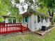 Exterior home with red deck, white siding, and black shutters at 988 Westfield Rd, Noblesville, IN 46062