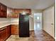 A kitchen featuring wooden cabinets and a full-size black refrigerator at 988 Westfield Rd, Noblesville, IN 46062