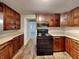 A kitchen featuring wooden cabinets and a black range at 988 Westfield Rd, Noblesville, IN 46062