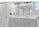 Stylish bathroom with double sinks, modern lighting, white cabinetry and quartz countertops for a clean design at 9917 Gallop Ln, Fishers, IN 46040