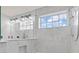 Modern bathroom boasts a tiled shower with a window, neutral palette, and updated fixtures at 9917 Gallop Ln, Fishers, IN 46040