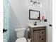 Stylish bathroom featuring modern fixtures, a vanity with sliding doors, and a framed mirror at 9917 Gallop Ln, Fishers, IN 46040