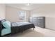 Neutral bedroom with a comfortable bed, a large window, and a modern gray dresser at 9917 Gallop Ln, Fishers, IN 46040