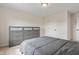 Neutral bedroom with comfortable bed, a large gray dresser, and a door at 9917 Gallop Ln, Fishers, IN 46040