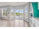 Sunlit breakfast nook with large windows and sliding doors leading to a patio with serene water views at 9917 Gallop Ln, Fishers, IN 46040
