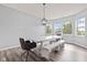 Charming dining area featuring a large wooden table, bench seating and stylish light fixture, perfect for gatherings at 9917 Gallop Ln, Fishers, IN 46040