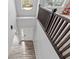 Bright entryway showcases light wood-look floors, a pendant light and a staircase with dark railings at 9917 Gallop Ln, Fishers, IN 46040