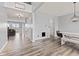 Inviting entryway with modern light fixtures, neutral walls, and beautiful hardwood flooring at 9917 Gallop Ln, Fishers, IN 46040
