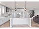 Modern kitchen with white cabinetry, stainless steel appliances, an island, and stylish pendant lighting at 9917 Gallop Ln, Fishers, IN 46040