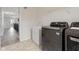 Laundry room features modern washer and dryer set, sink, and views of the hallway at 9917 Gallop Ln, Fishers, IN 46040