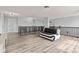 Spacious loft area with modern decor, hardwood floors, and a seating area at 9917 Gallop Ln, Fishers, IN 46040