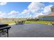 Outdoor patio has dining table with chairs and barbecue grill with water view at 9917 Gallop Ln, Fishers, IN 46040