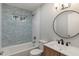 This bathroom has decorative wall tile and updated fixtures at 1002 Collier St, Indianapolis, IN 46241