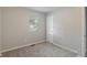 This bedroom has neutral carpet and one window at 1002 Collier St, Indianapolis, IN 46241