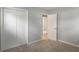 This bedroom has neutral carpet and white closet doors at 1002 Collier St, Indianapolis, IN 46241