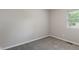 This bedroom has neutral carpet, one window, and light-colored walls at 1002 Collier St, Indianapolis, IN 46241