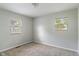 This bedroom has neutral carpet, two windows, and light-colored walls at 1002 Collier St, Indianapolis, IN 46241