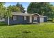 Well-kept home featuring blue siding, a covered porch, and an attached garage at 1002 Collier St, Indianapolis, IN 46241