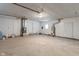 A large open garage with concrete floors and two doors at 1002 Collier St, Indianapolis, IN 46241
