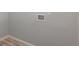 Laundry hookups are installed on the wall above light colored wood laminate flooring at 1002 Collier St, Indianapolis, IN 46241
