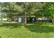 Spacious yard showcasing the home's exterior, complete with lush greenery and mature trees at 1002 Collier St, Indianapolis, IN 46241