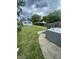 Spacious backyard featuring a concrete platform, grassy area, and some trees at 1021 W 37Th St, Indianapolis, IN 46208