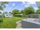 Fenced backyard with a small outbuilding and lush greenery and access to home at 1021 W 37Th St, Indianapolis, IN 46208