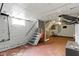 Unfinished basement with stairs, window, exposed ducts, and painted floor at 1021 W 37Th St, Indianapolis, IN 46208