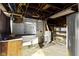 Unfinished basement offering potential with exposed pipes and block walls for customization at 1021 W 37Th St, Indianapolis, IN 46208