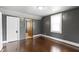Bedroom featuring gray walls, wood floors, a closet, and a window at 1021 W 37Th St, Indianapolis, IN 46208